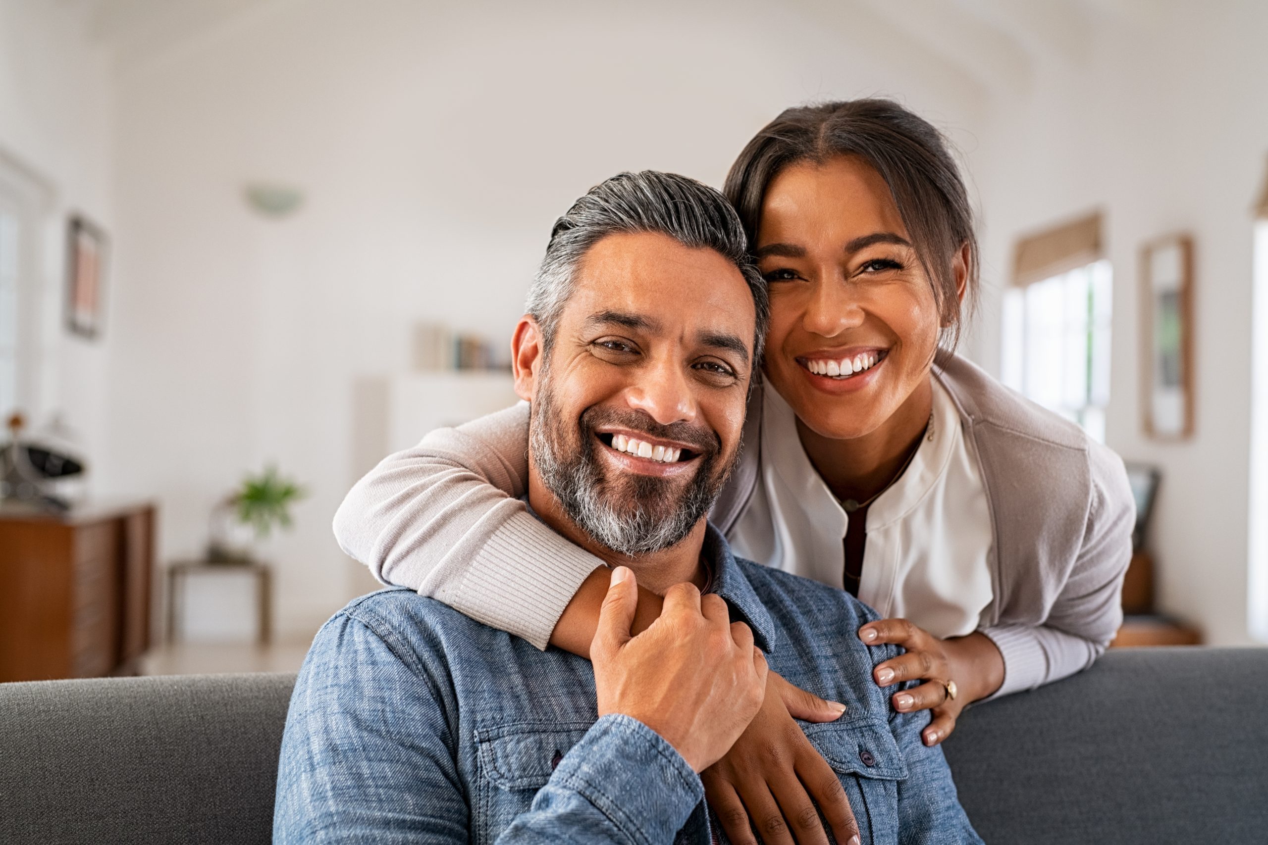 Mature Indian Couple Hugging And Looking At Camera